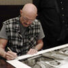 Tony Levin signing a 20x30" print of "On the shinkansen, 1981"