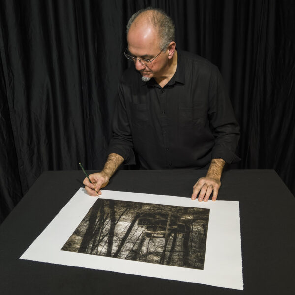 Jerry LoFaro signing his special edition duotone intaglio print of "Ghost of Gulf Road".