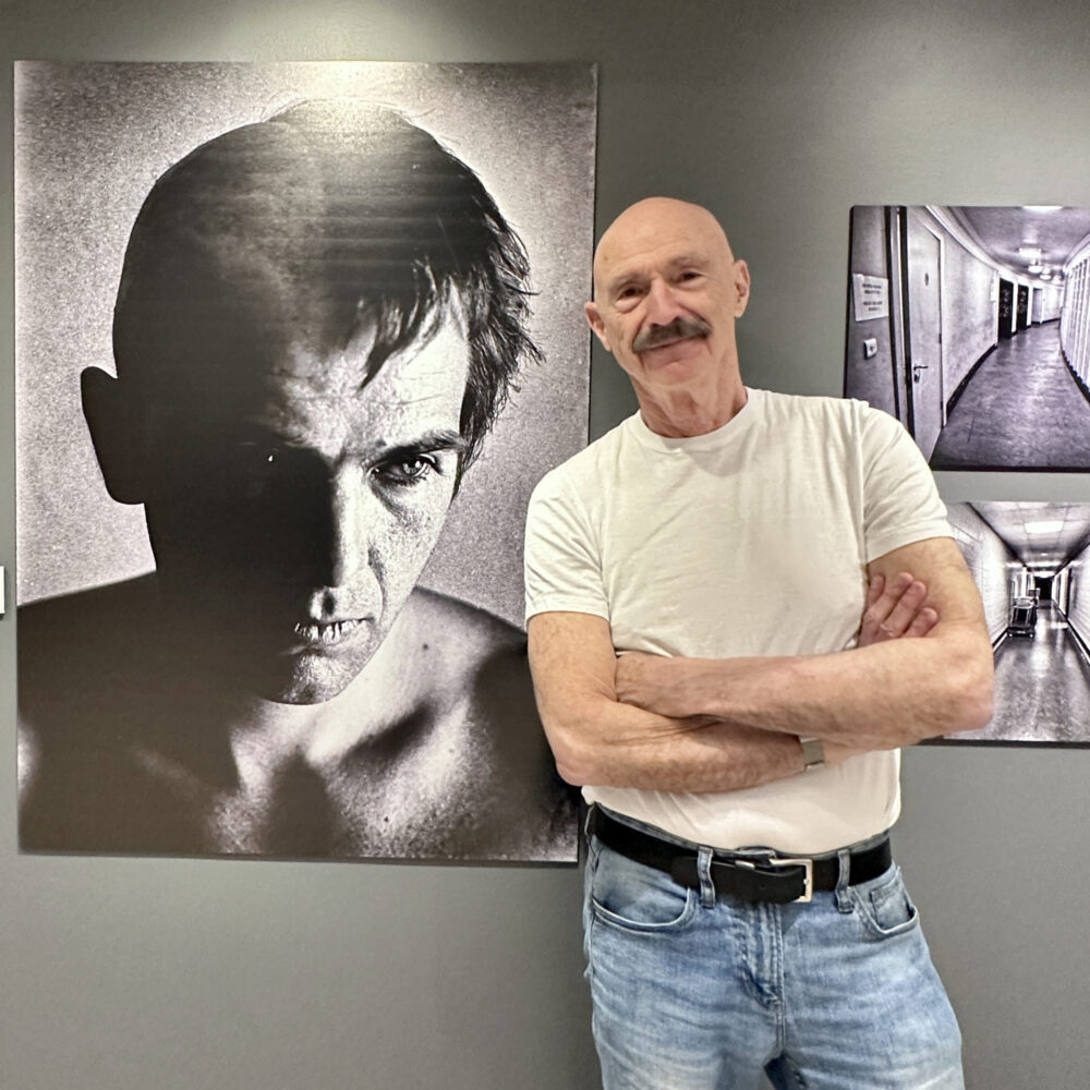 Tony Levin with his large portrait "Peter Gabriel, 1980" at the Haggin Museum in Stockton, CA, Feb 16, 2023