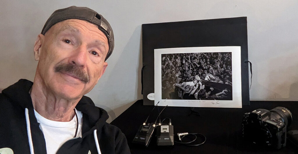 Tony Levin with his signed, inkjet print of "Lay Your Hands on Me, 1987"