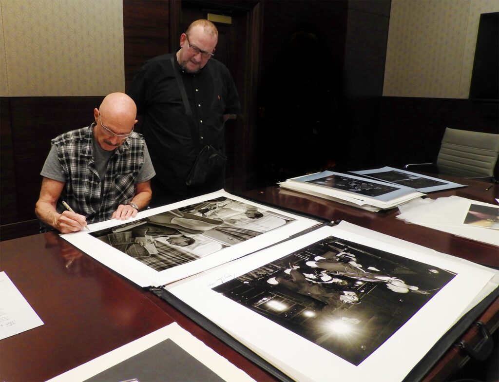 Tony Levin print signing with King Crimson road manager, Dave Salt in 2021.