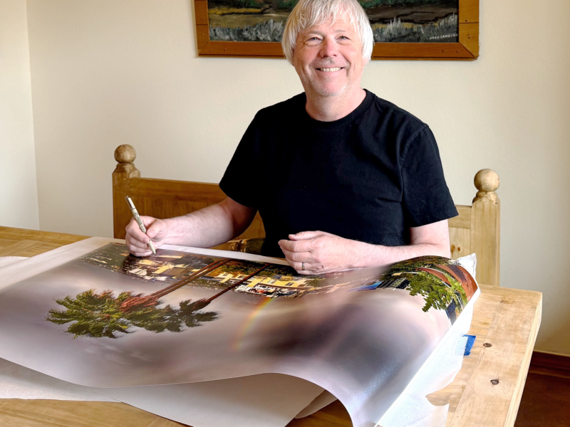Paul Richards signing the commissioned print "Big LA Rainbow".